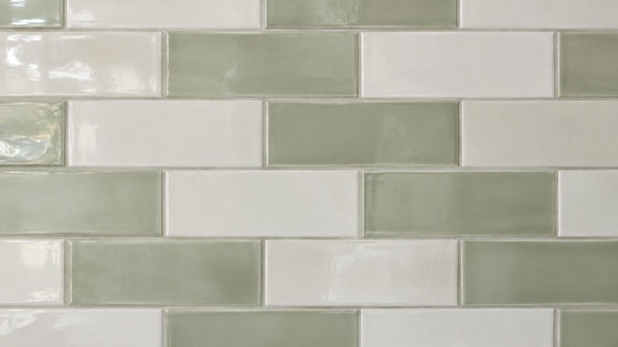 Glossy white and sage-green ceramic subway tile splashback