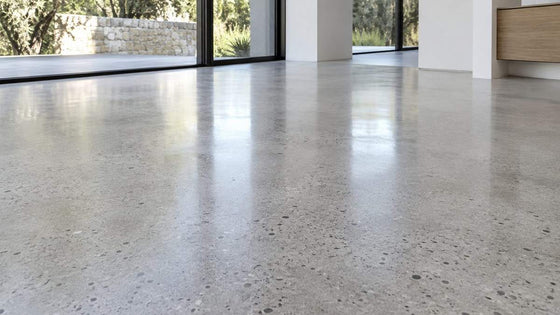 Honed light grey concrete floor in a bright modern home
